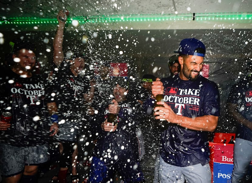Texas Rangers second baseman Marcus Semien celebrates clinching a playoff spot in the...