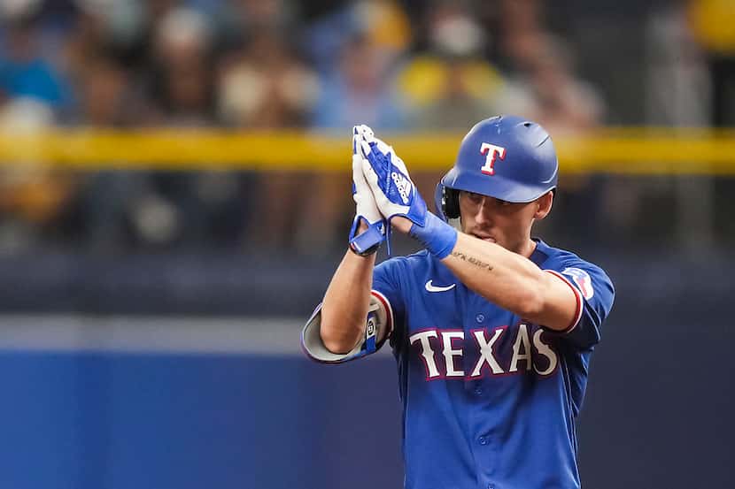 Texas Rangers left fielder Evan Carter celebrates after hitting a leadoff double during the...
