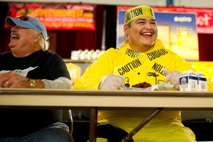 Gino Lopez competes in a wing eating contest during ZestFest at the Irving Convention...