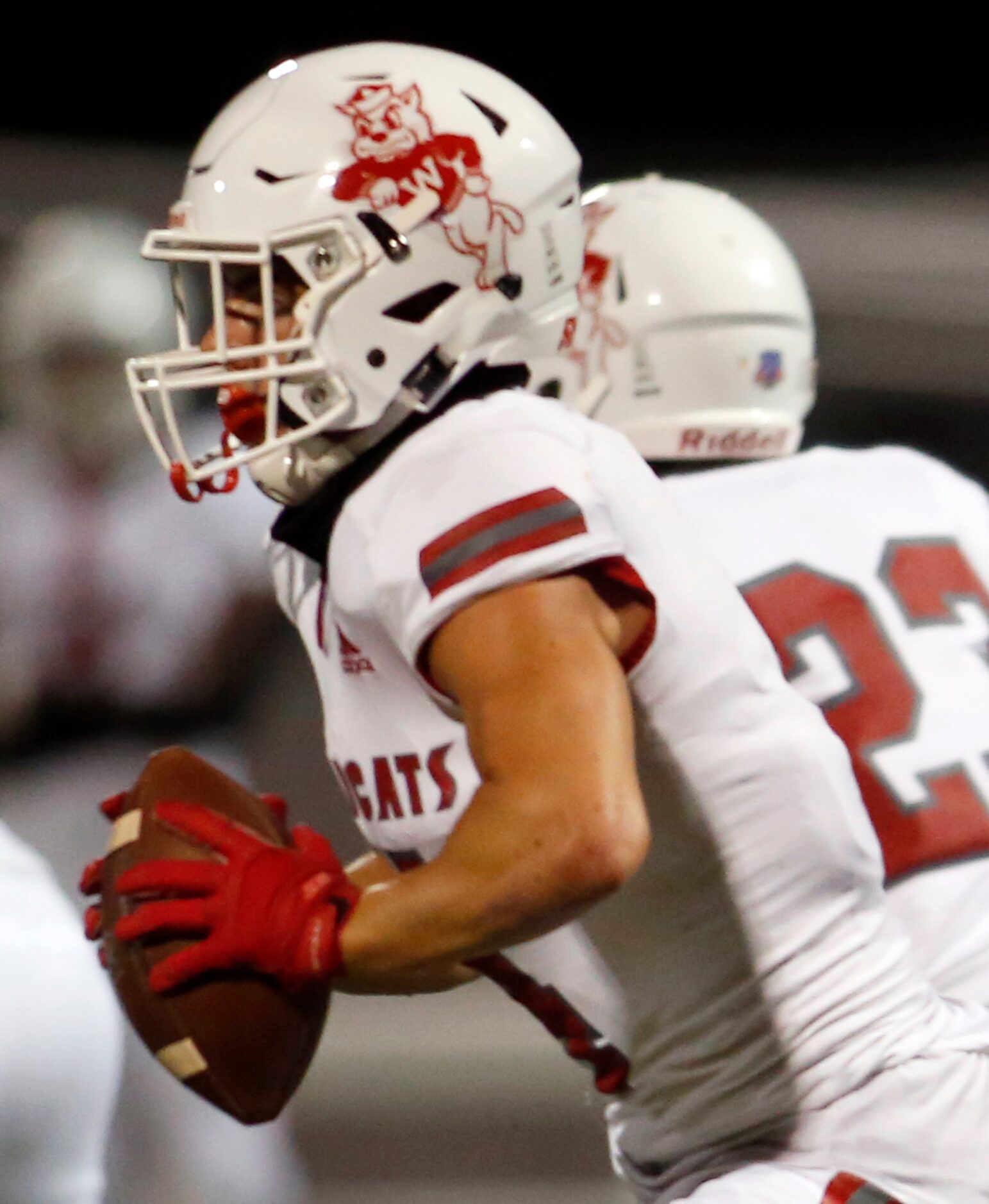 Dallas Woodrow Wilson quarterback Cooper Alford (10) looks to roll out of the Wildcats...