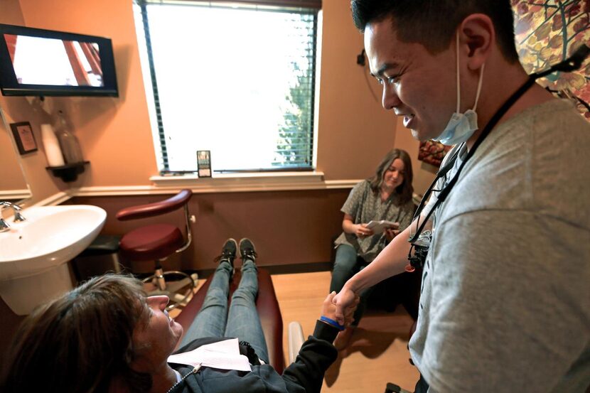 
Dr. Anthony Do greets Donna Johnson during the Smiles Giving Day"at Red Oak Family...