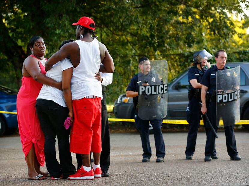 Lashaun Bradford (far left) joined others including her son Raymon Bradford (in red hat) at...