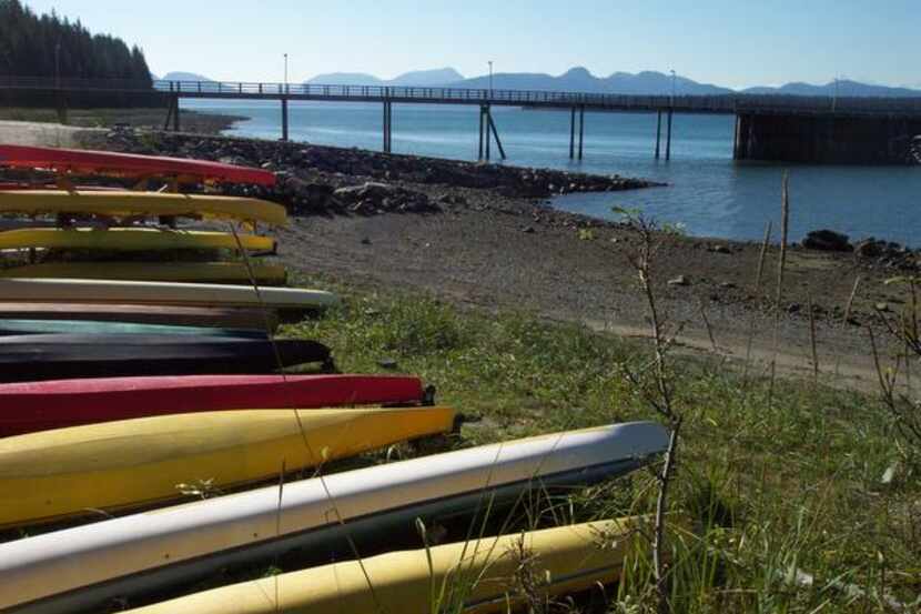 
Kayaks are ready to go along the shore at Bartlett Cove in Glacier Bay National Park &...