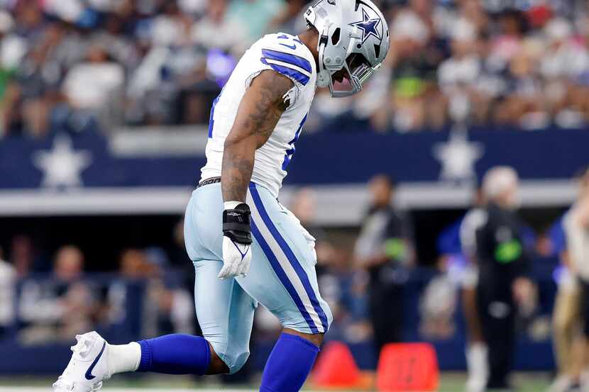 Dallas Cowboys linebacker Micah Parsons (11) limps back to the sideline after coming back in...