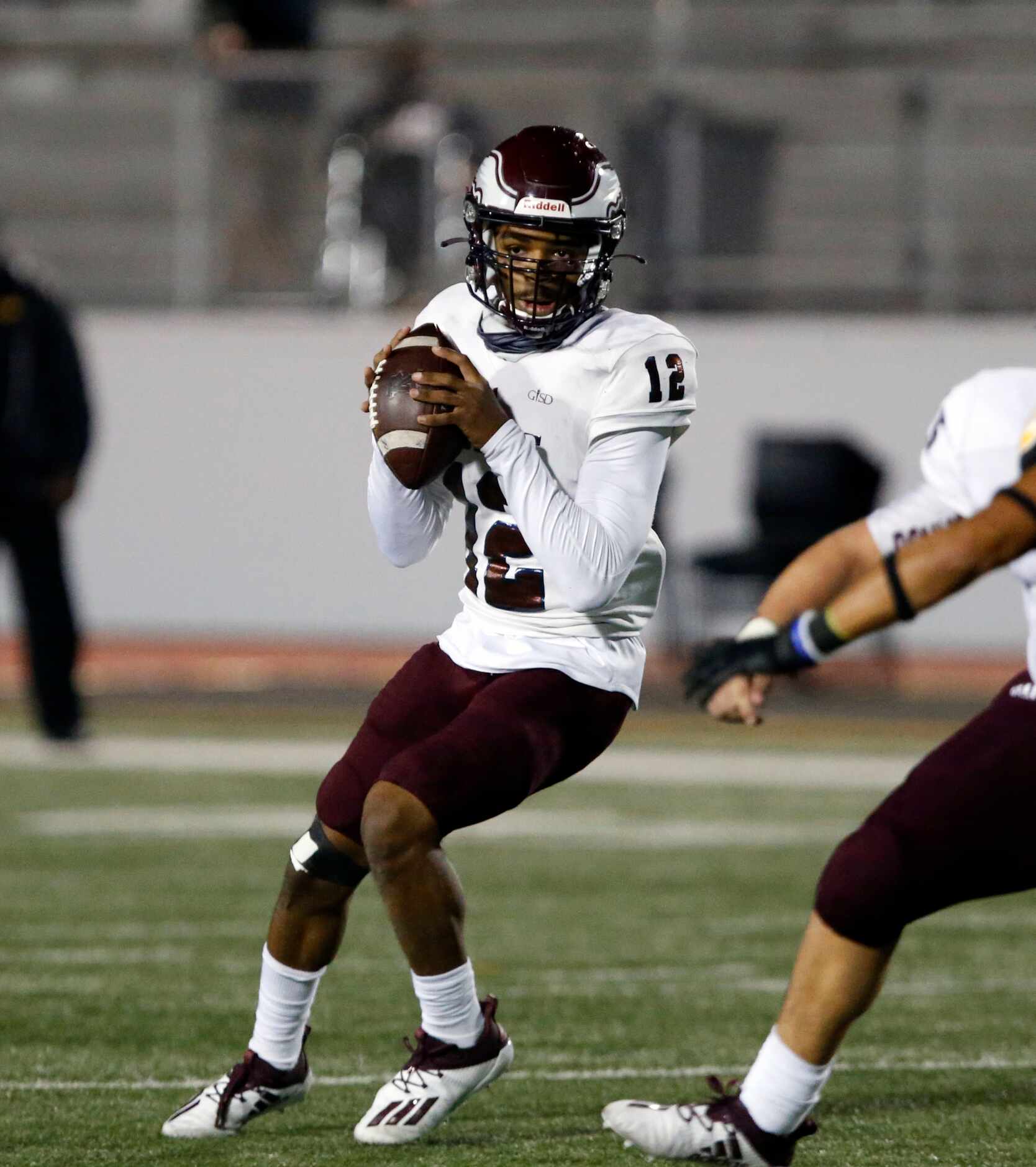 Rowlett QB Tre Carr (12) prepares to pass the ball during the first half of high school...