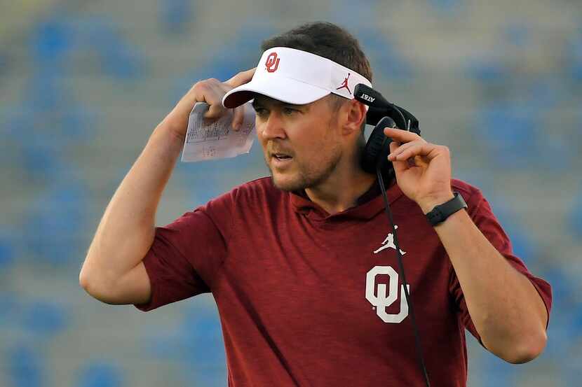 Oklahoma coach Lincoln Riley stands on the sideline during the first half of the team's NCAA...