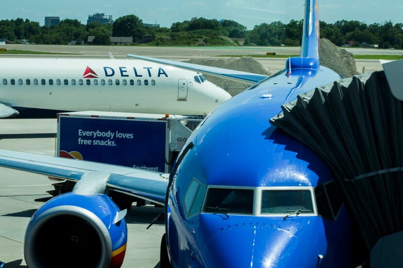  Delta Airlines flight 2055, a Boeing 717-200 bound for Atlanta, taxis past a Southwest...