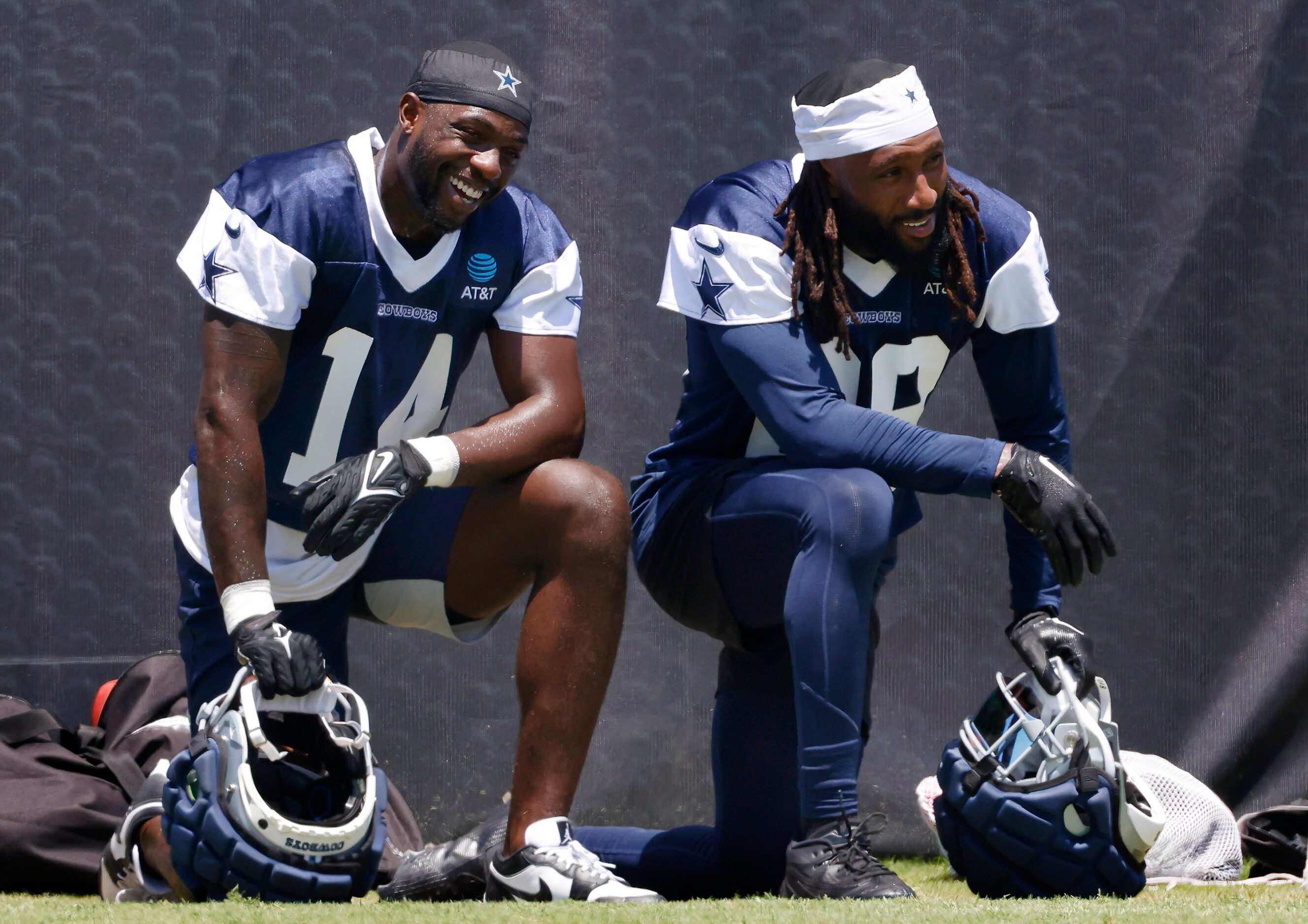 Dallas Cowboys safety Malik Hooker (28, right) takes a knee on the sideline as he takes a...