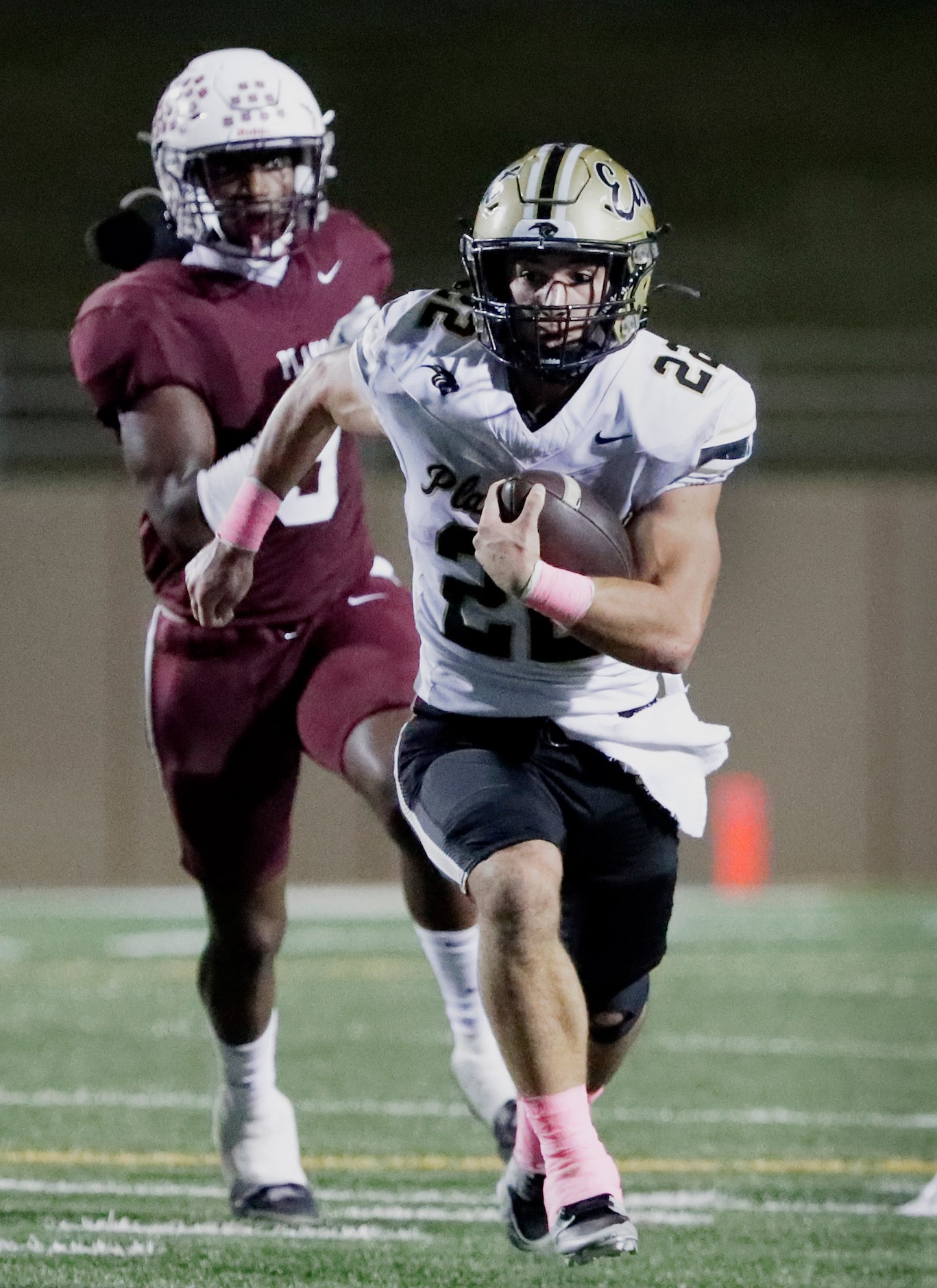 Plano East High School running back Travis Agee (22) is chased by Plano High School...