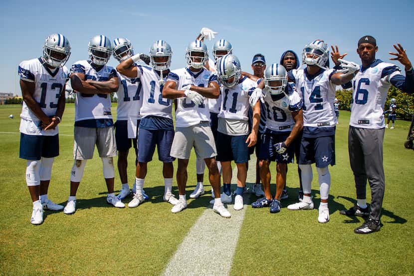 Dallas Cowboys wide receivers pose for a photo around wide receivers coach Sanjay Lal...