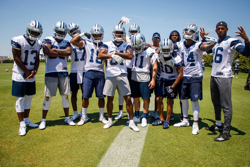 Dallas Cowboys wide receivers pose for a photo around wide receivers coach Sanjay Lal...