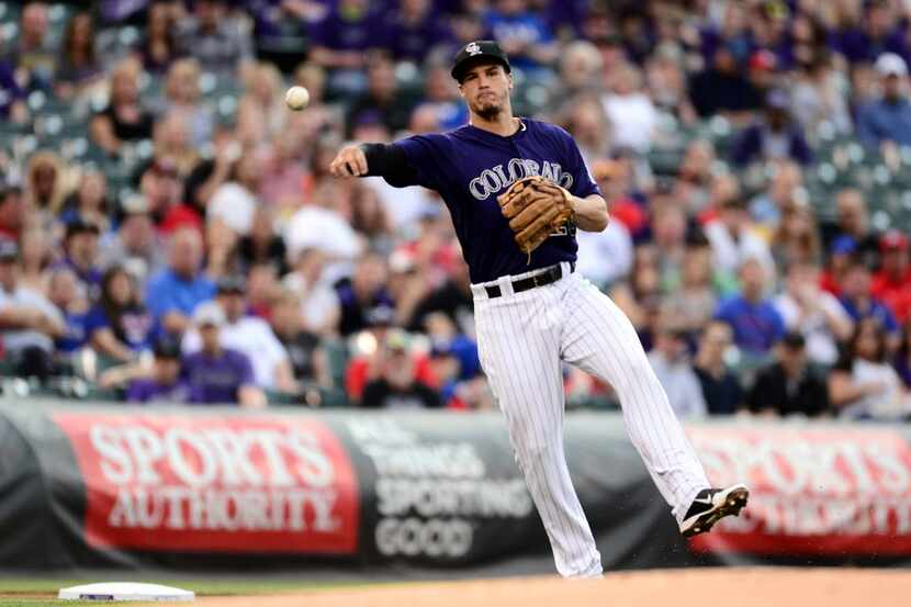 May 5, 2014; Denver, CO, USA; Colorado Rockies third baseman Nolan Arenado (28) throws to...