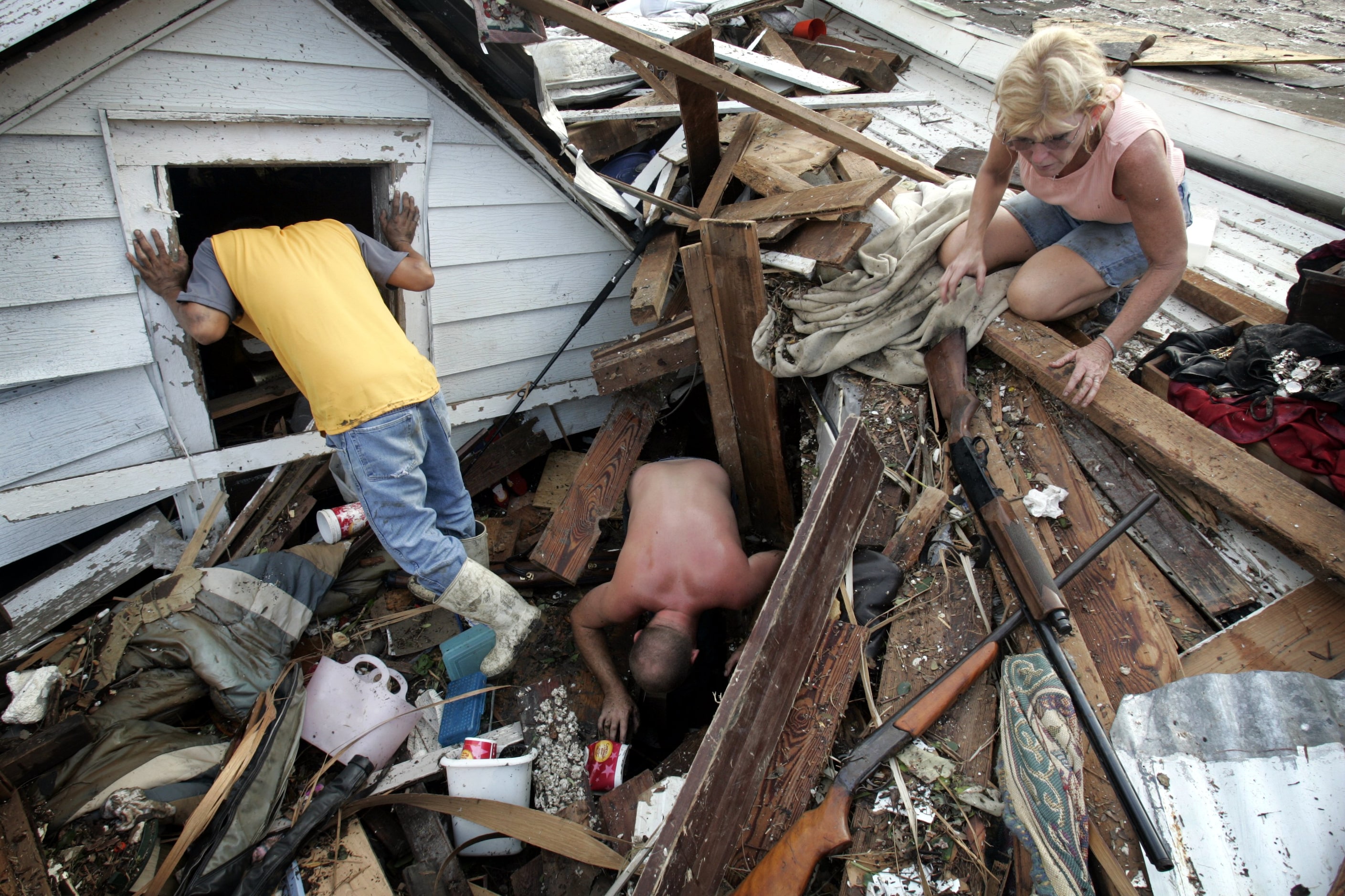 Tam Cu, Jason Jackson and Linda Bryant looked for belongings from Ms. Bryant's home which...