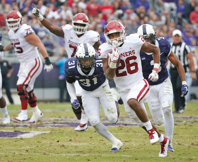 Oklahoma Sooners running back Kennedy Brooks (26) motors downfield on a long second-quarter...