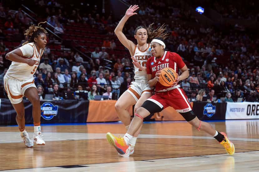 North Carolina State guard Zoe Brooks, right, drives to the basket as Texas guard Shay Holle...