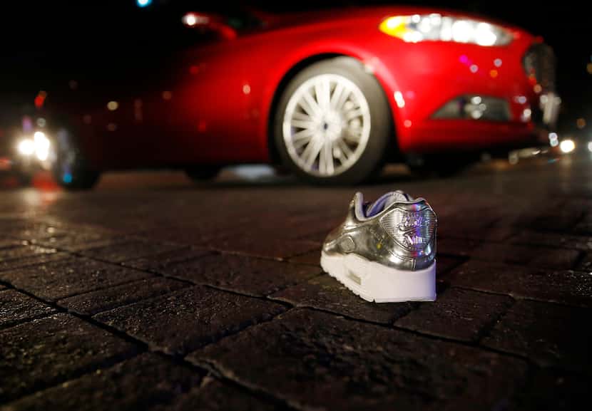 A lone shoe from Sneaker Politics sits in the middle of Main Street in Deep Ellum east of...