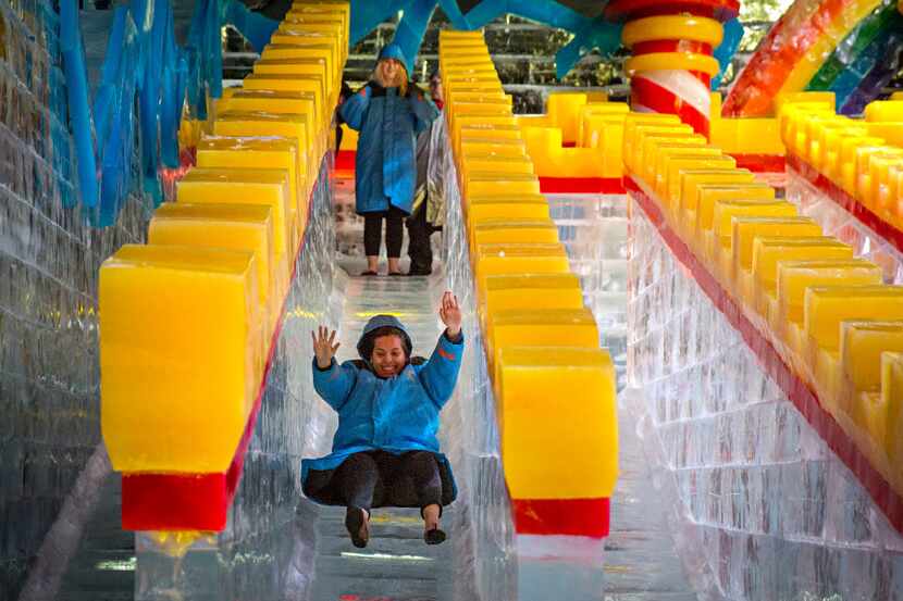Carla Lule tries out the ice slide at the "Ice!" exhibit in 2019 at the Gaylord Texan Resort.