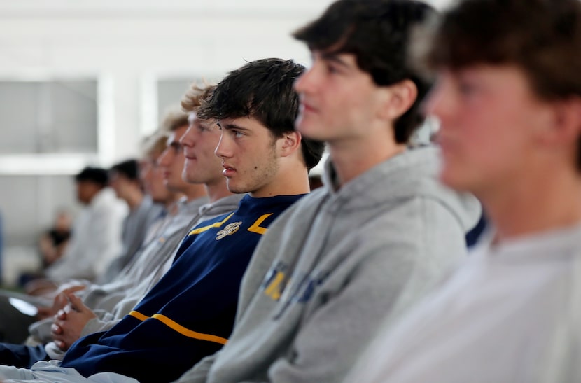 Students listen as the Haas Formula 1 team presents during a STEAM education challenge at...