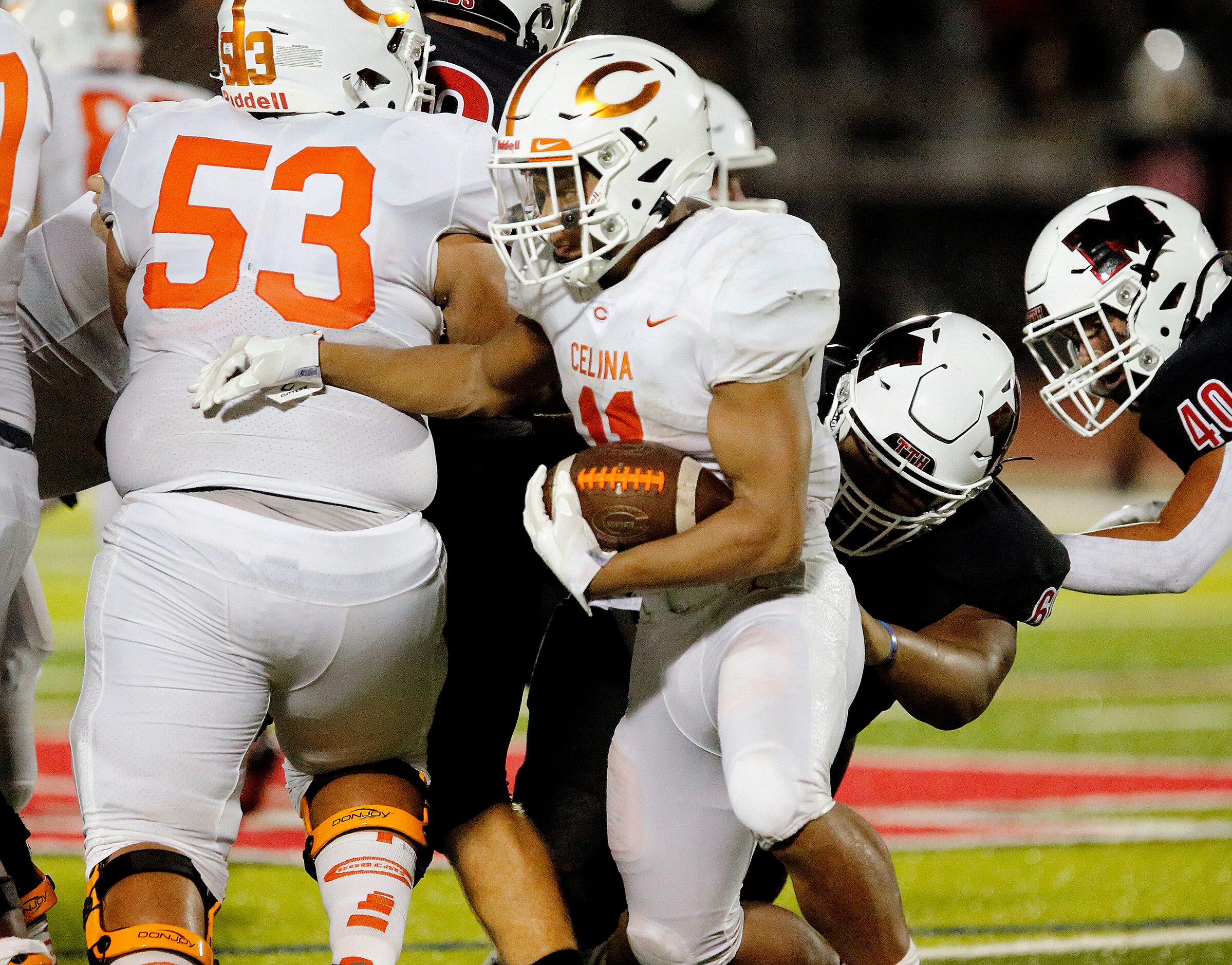 Celina High School running back Gabe Gayton (11) runs behind Celina High School offensive...