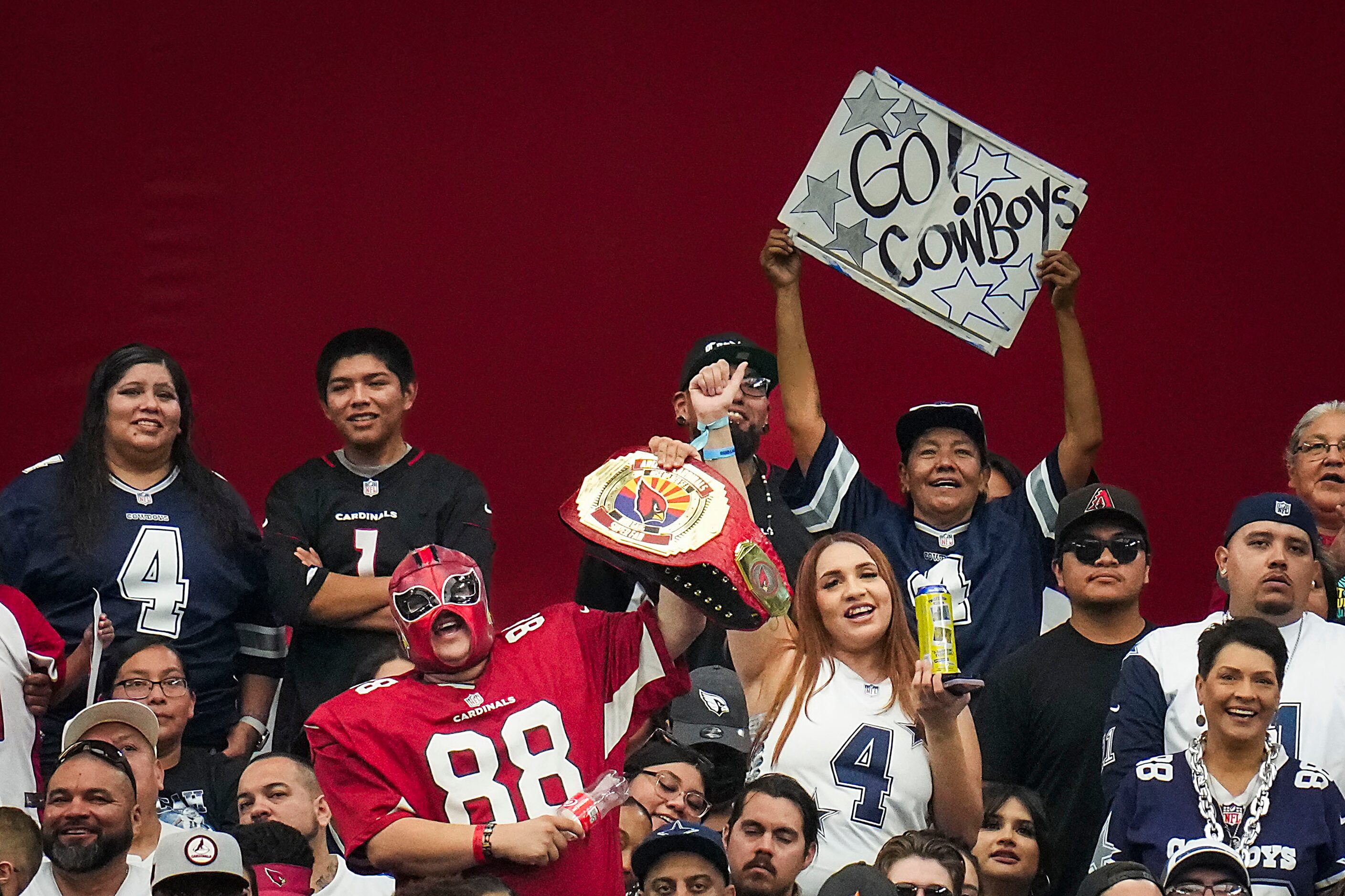 Dallas Cowboys fans cheer their team during the first half of an NFL football game Arizona...