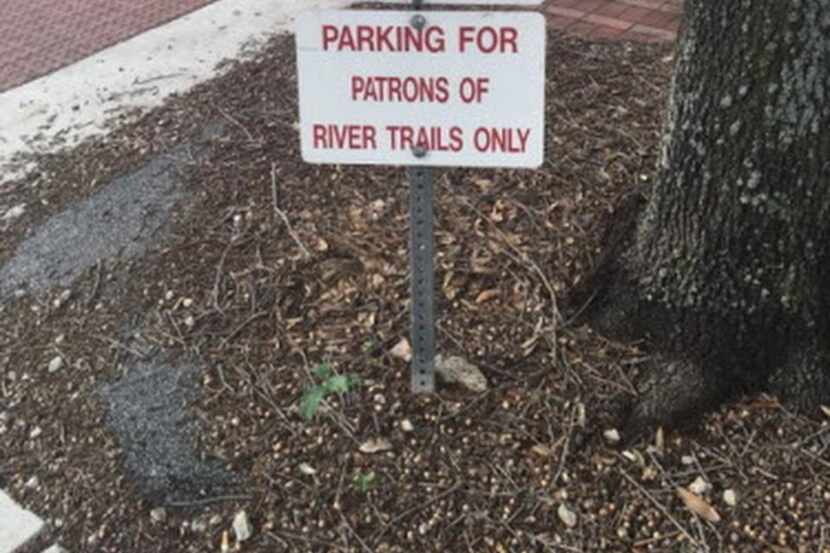 
A towing sign in a parking area for River Trails in Tarrant County could give motorists a...