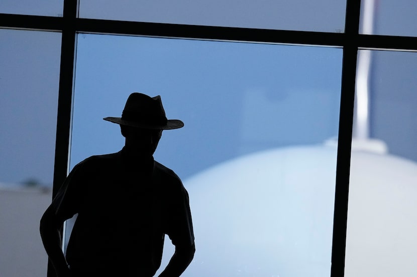 A person looks out the window as athletes from Team U.S. depart from the airport on...