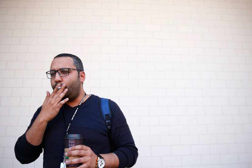 Mohamed Khattab, 27, smokes a cigarette outside El Centro College in downtown Dallas on...