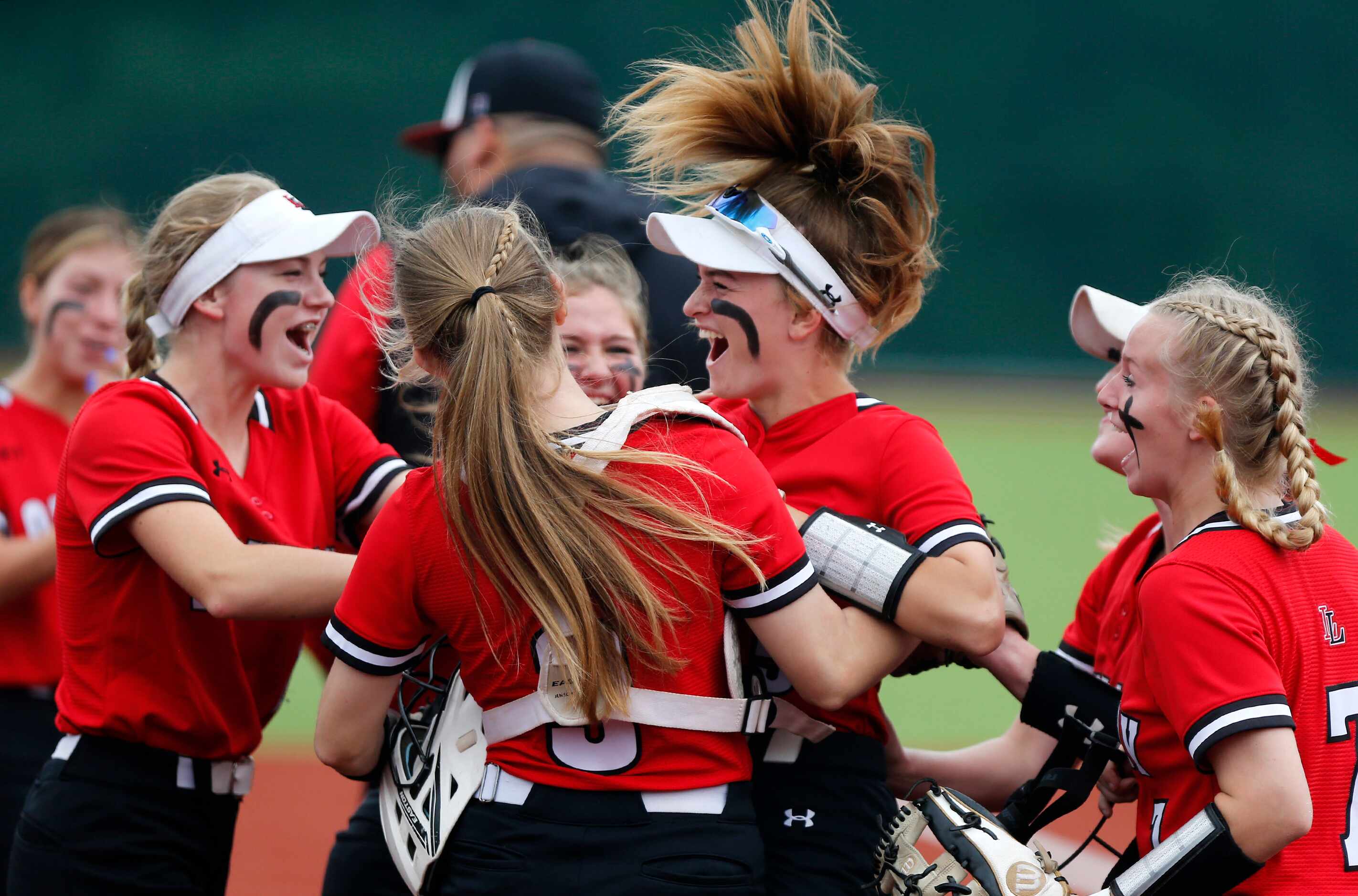 Lovejoy team mates surround shortstop Skylar Rucker (center) after she tagged out a stolen...