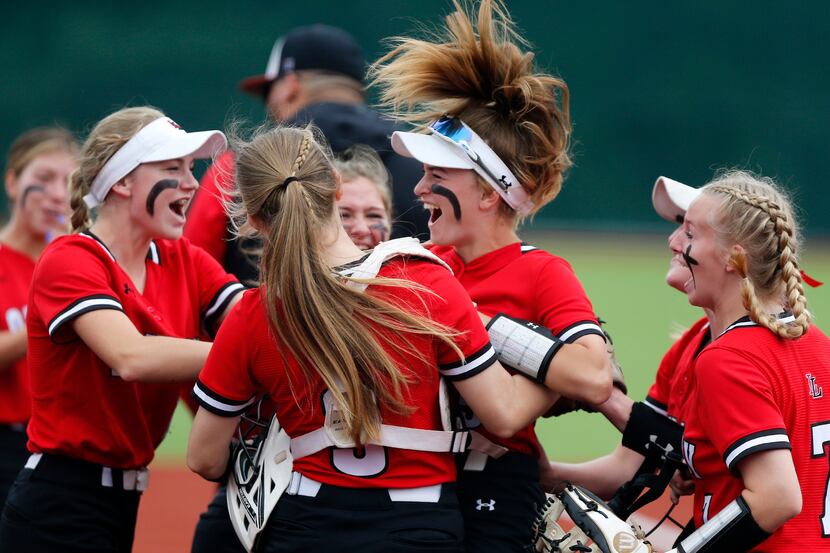 Lovejoy players celebrate with shortstop Skylar Rucker (center) after she tagged out a...
