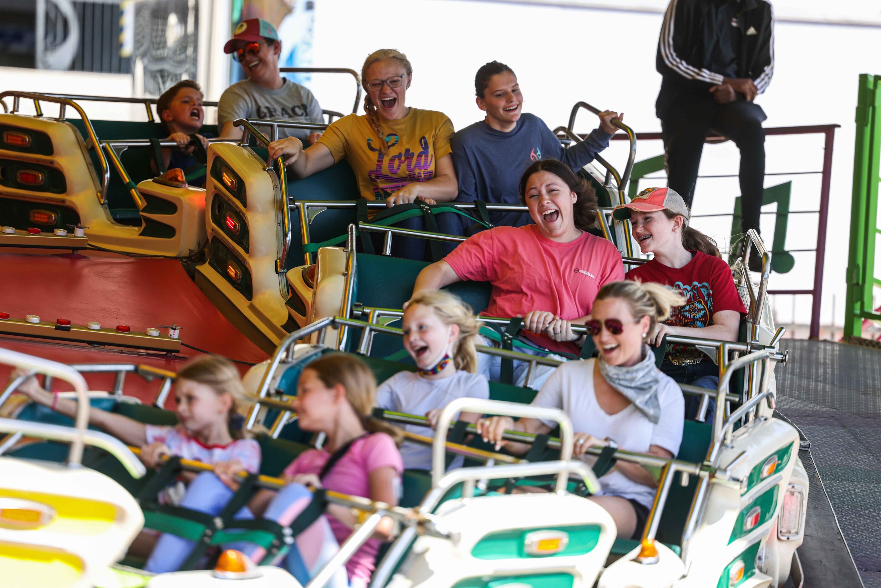 People  aboard a carnival ride at the State Fair of Texas during its opening day in Dallas...