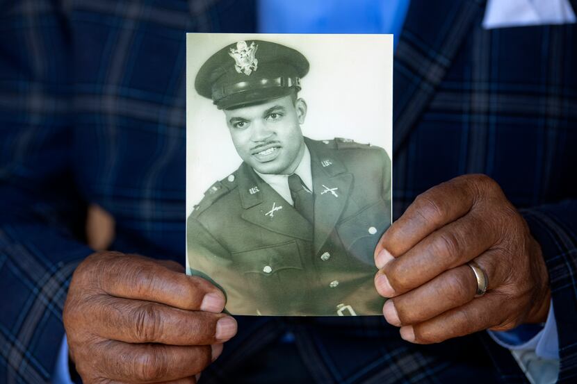 Ezell Holley, 90, holds a 1953 photo taken when he was a second lieutenant in the Army.
