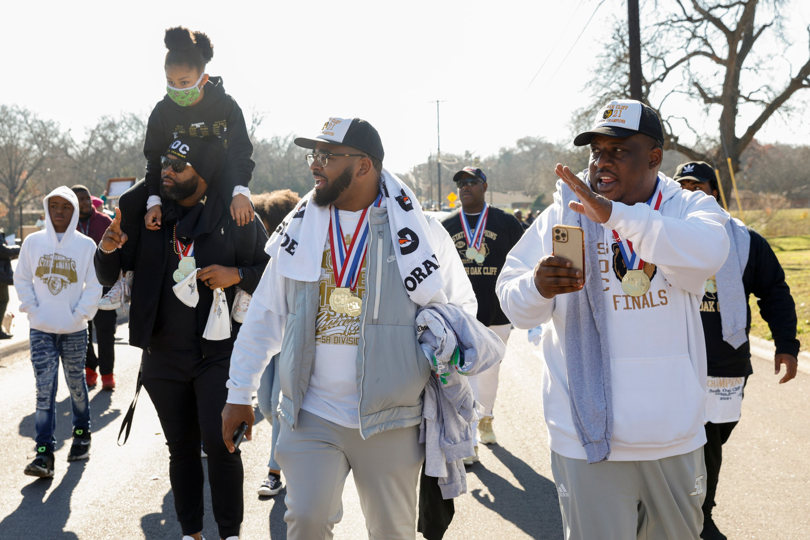 South Oak Cliff head coach Jason Todd (right) waves to the crowd alongside assistant coach...