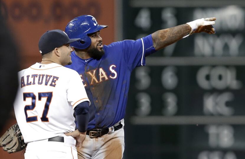 Texas Rangers' Prince Fielder, right, points out the replay video to Houston Astros second...