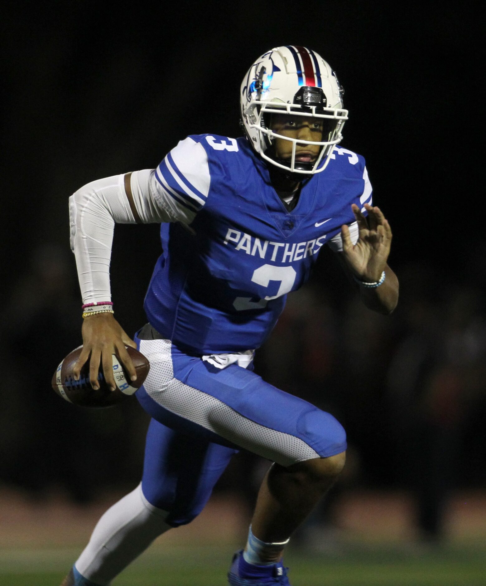 Duncanville quarterback Grayson James (3) rolls out of the backfield on a quarterback keeper...