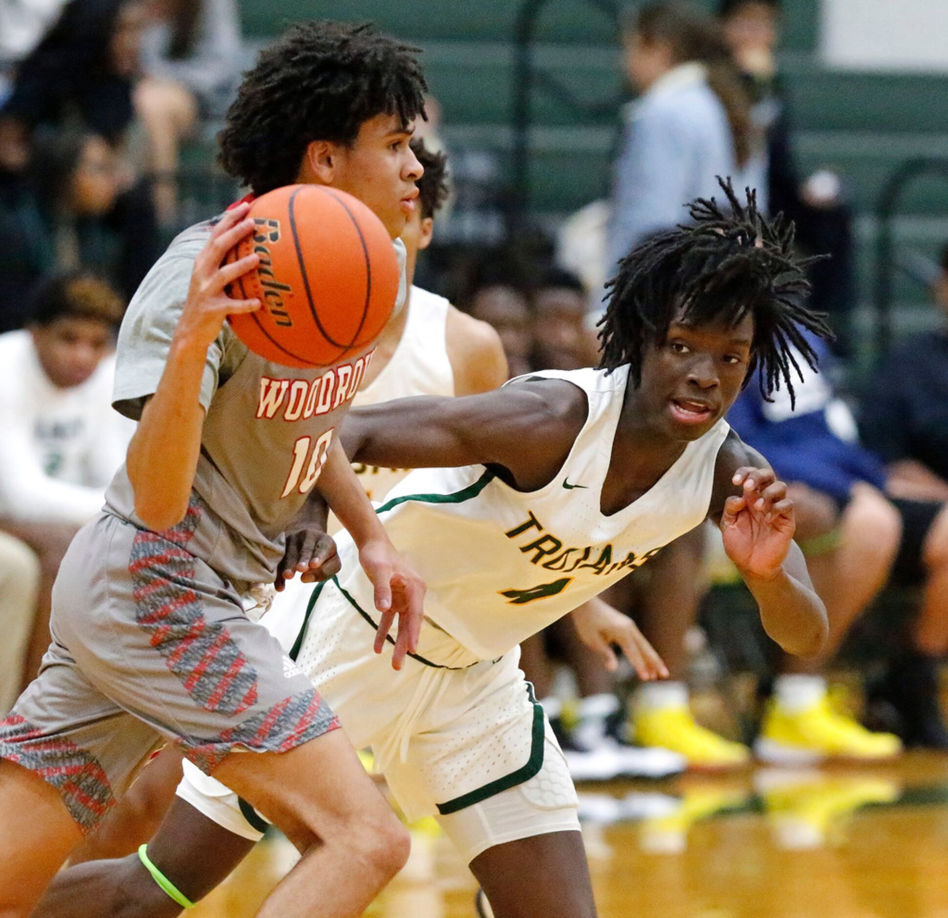 Woodrow Wilson High School guard Grant Goosby (10) is defended by Newman Smith High School...