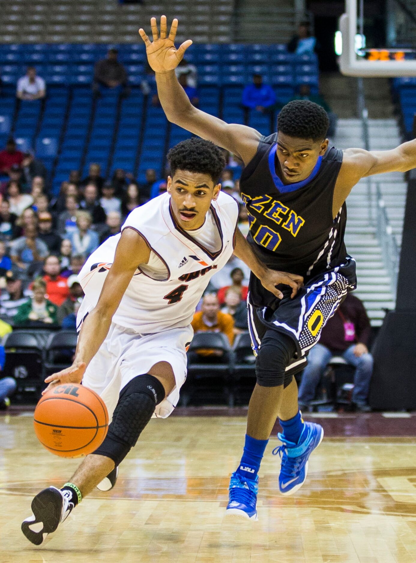 Lancaster guard Ike Durham (4) gets away from Beaumont Ozen guard/forward Richard Maxey (30)...