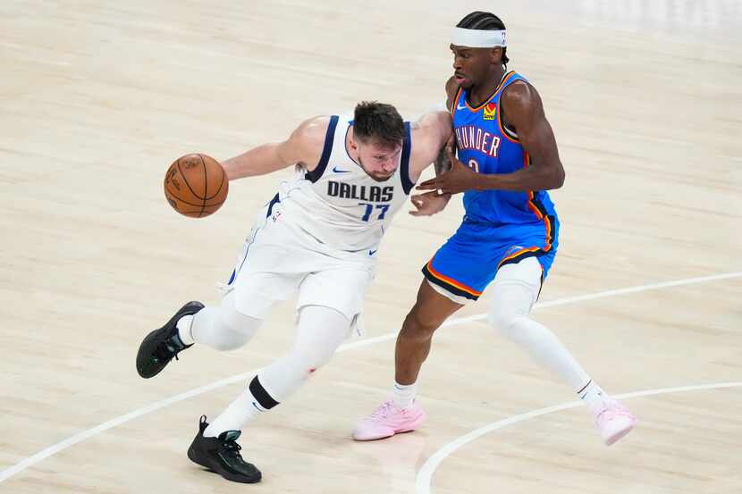 Dallas Mavericks guard Luka Doncic (77) drives on Oklahoma City Thunder guard Shai...