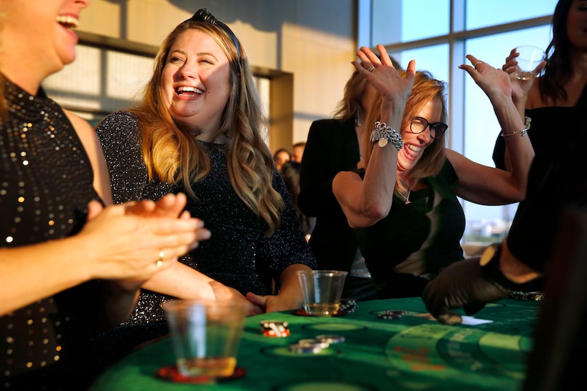 Monument Realty agents Kristi Drayovitch (center) and Brenda Sukenik (right) celebrate a...