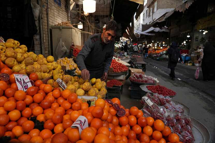 A fruit seller arranges his fruits at a local market in Tehran, Iran, ahead of the Persian...