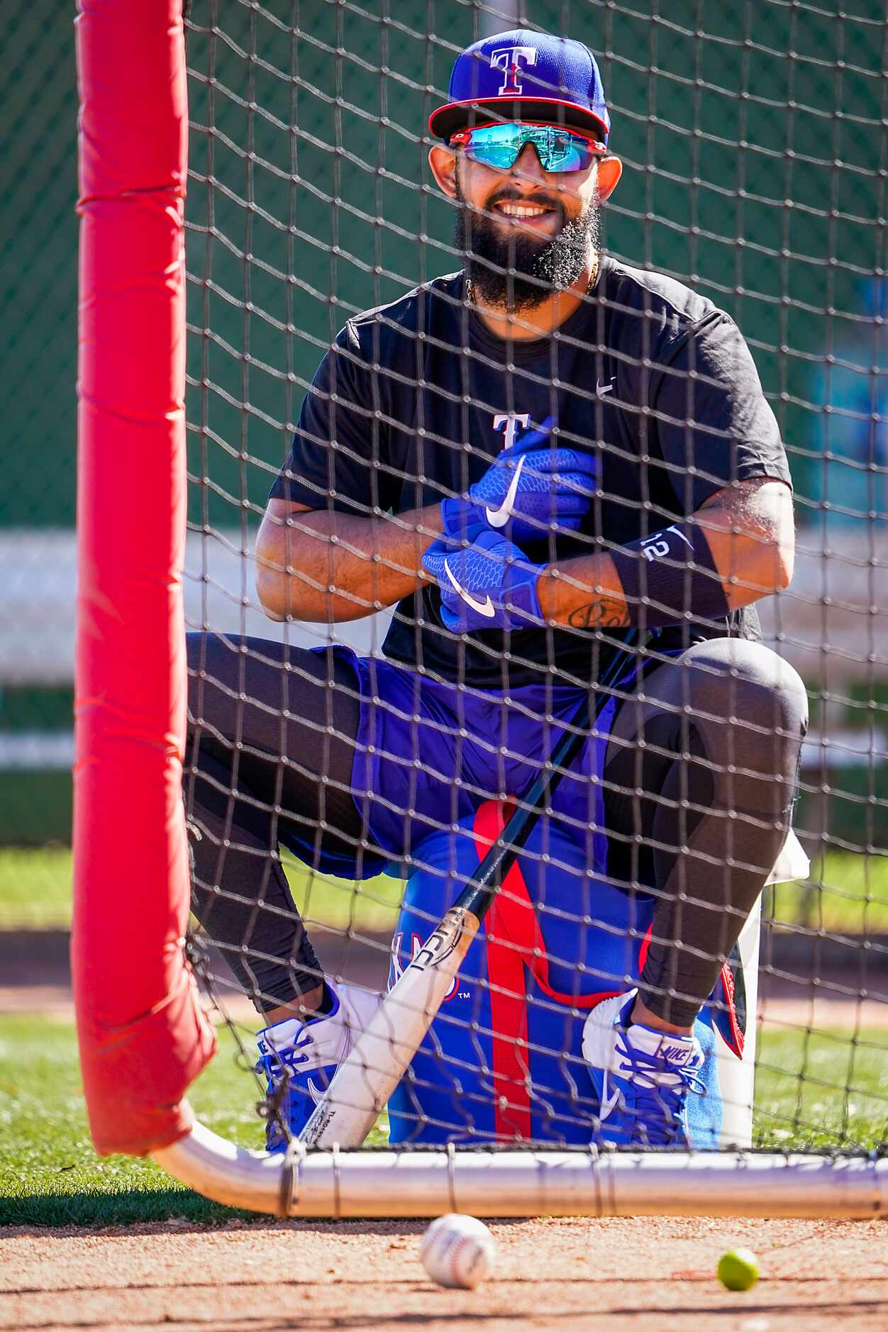 Texas Rangers second baseman Rougned Odor waits his turn in the cage while taking batting...