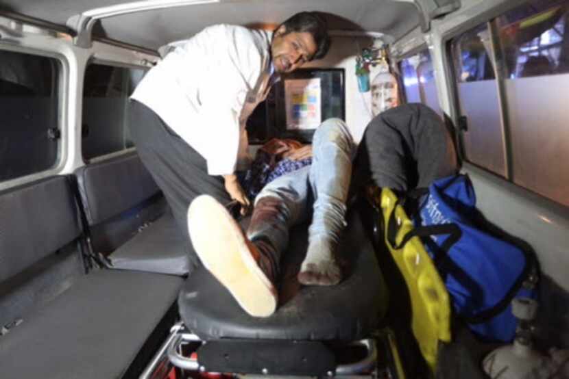 A wounded person is treated in an ambulance after a Taliban attack on the campus of the...