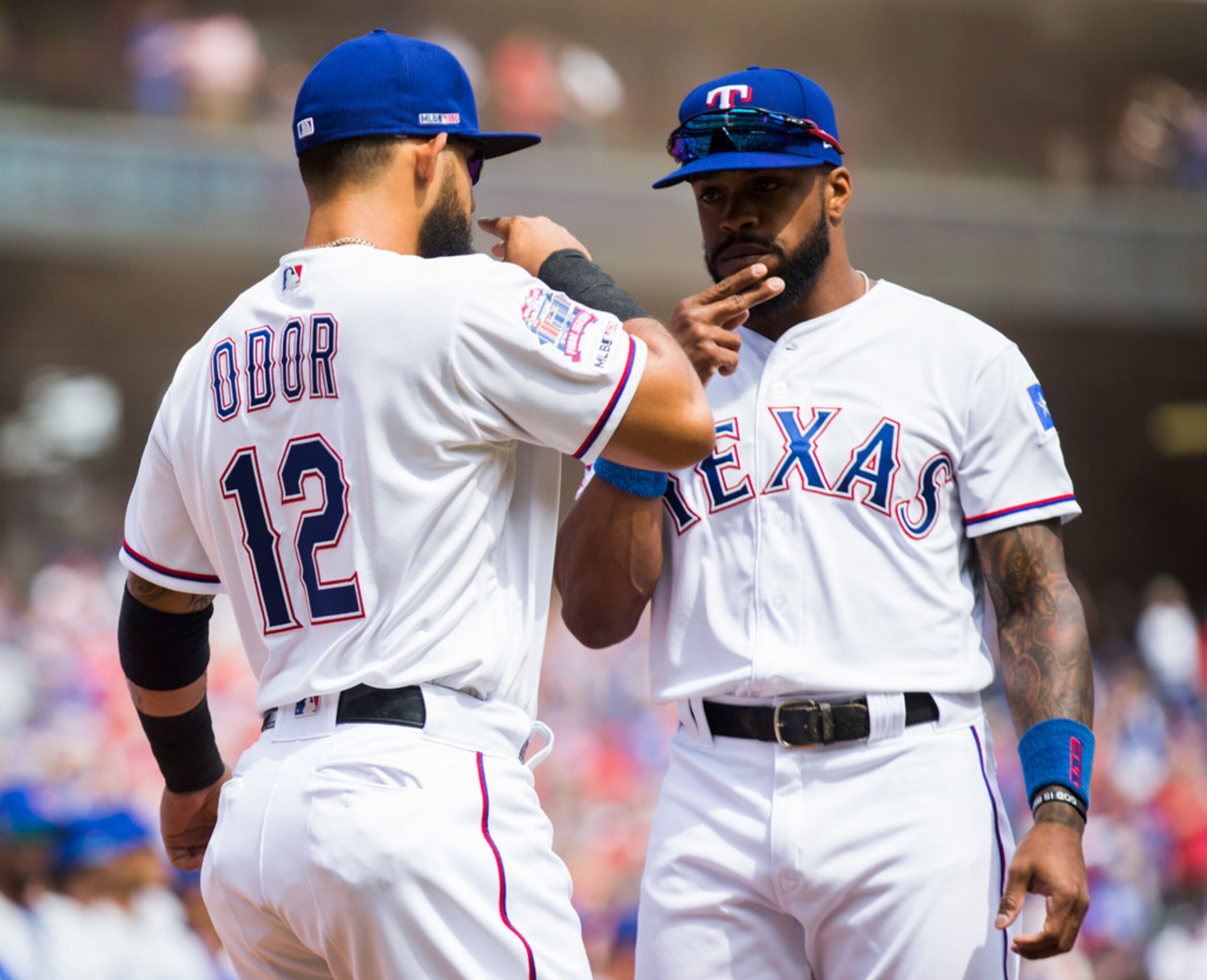 Texas Rangers second baseman Rougned Odor (12) and center fielder Delino DeShields (3) greet...