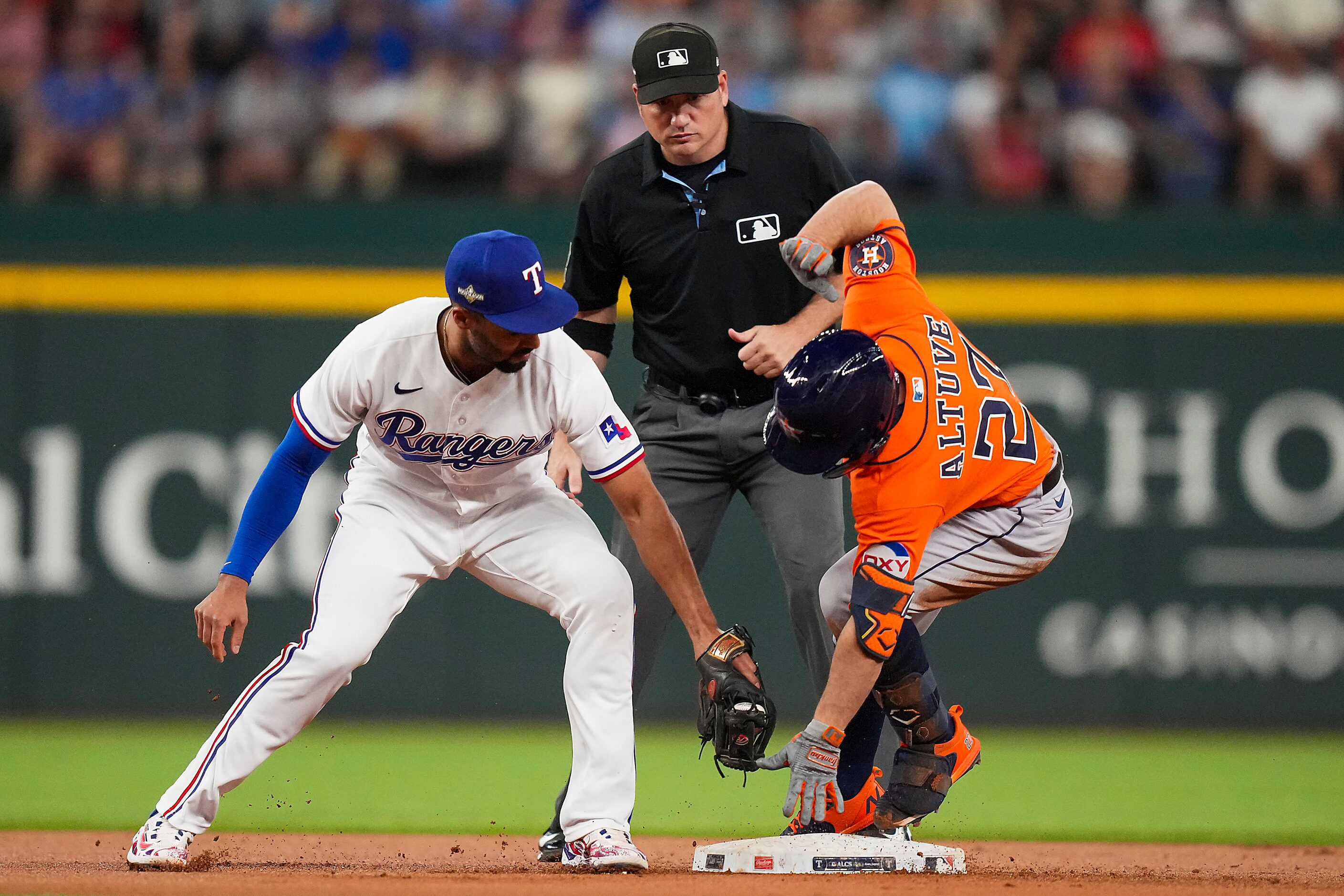 Houston Astros second baseman Jose Altuve (27) is safe at second as Texas Rangers second...