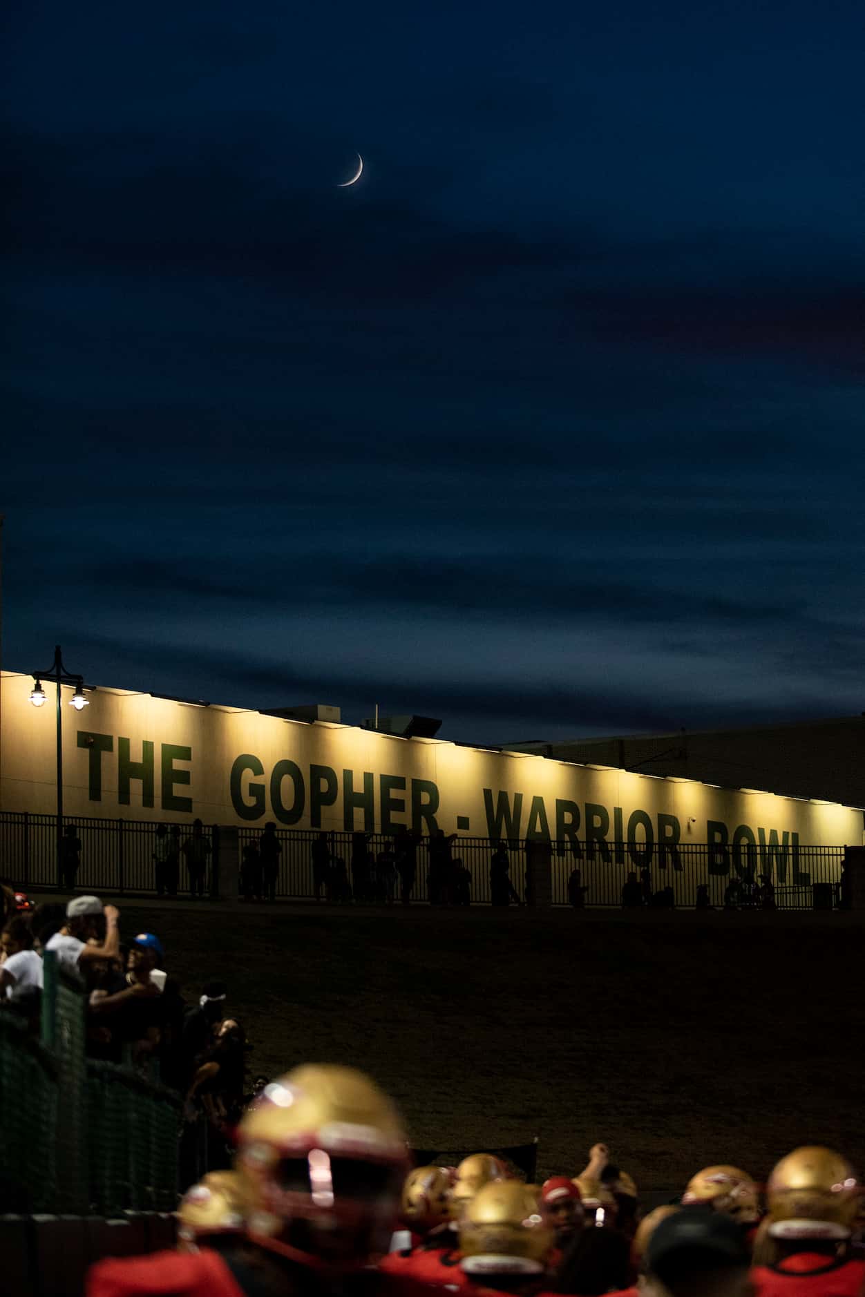 The moon is visible behind the Gopher-Warrior Bowl during South Grand PrairieÕs game against...