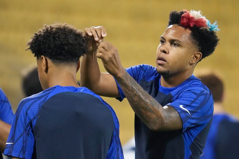 Weston McKennie, right, of the United States, touches Tyler Adams' hair during an official...