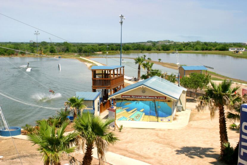 Texas Ski Ranch features three lakes for active water sports. In one lake, boats tow skiers,...