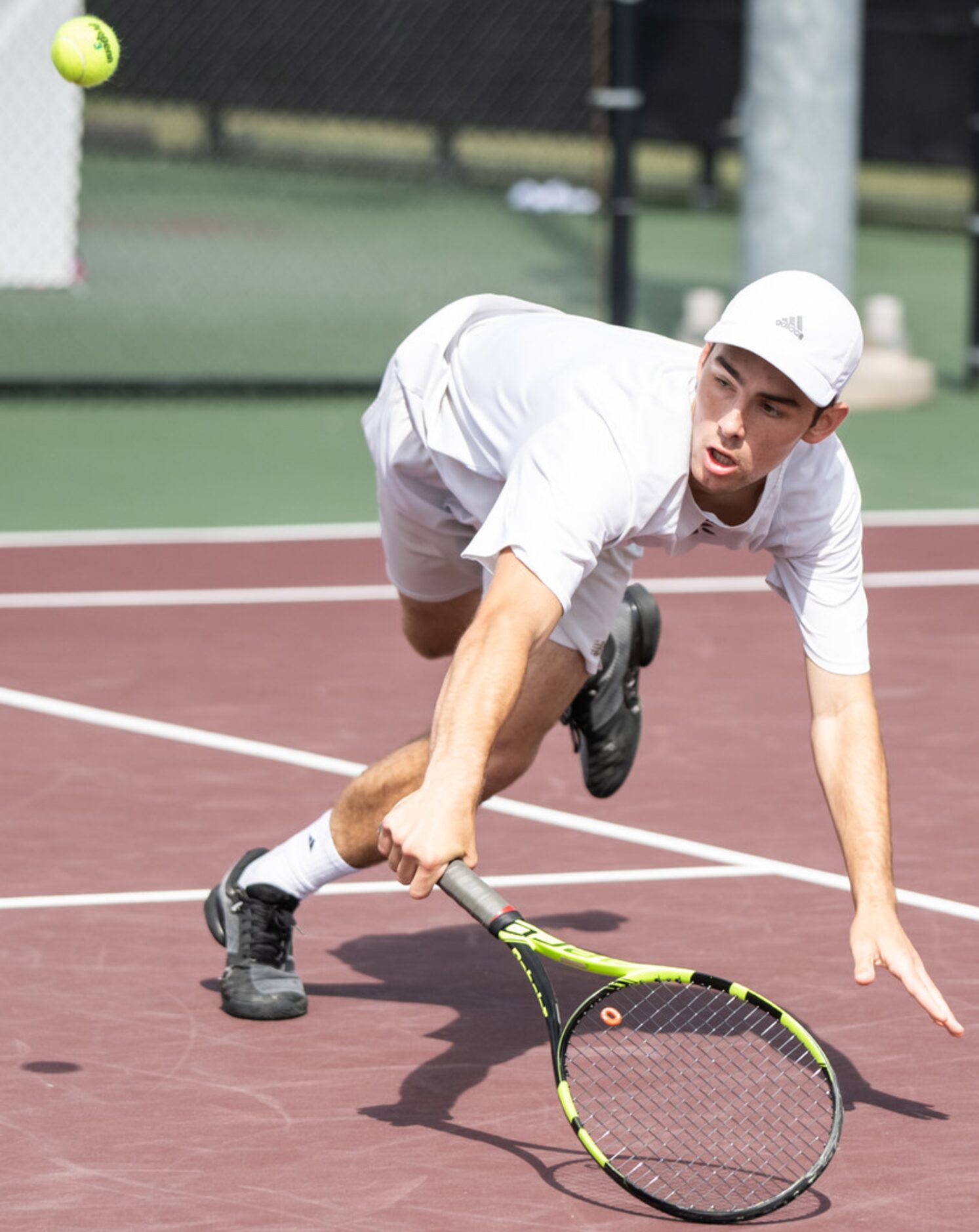 Plano's Edward Shteyn returns the ball in a doubles match with teammate Herman Aguirre in a...