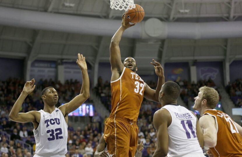 Texas forward Shaquille Cleare (32) pulls in a rebound next to TCU forward Karviar Shepherd,...