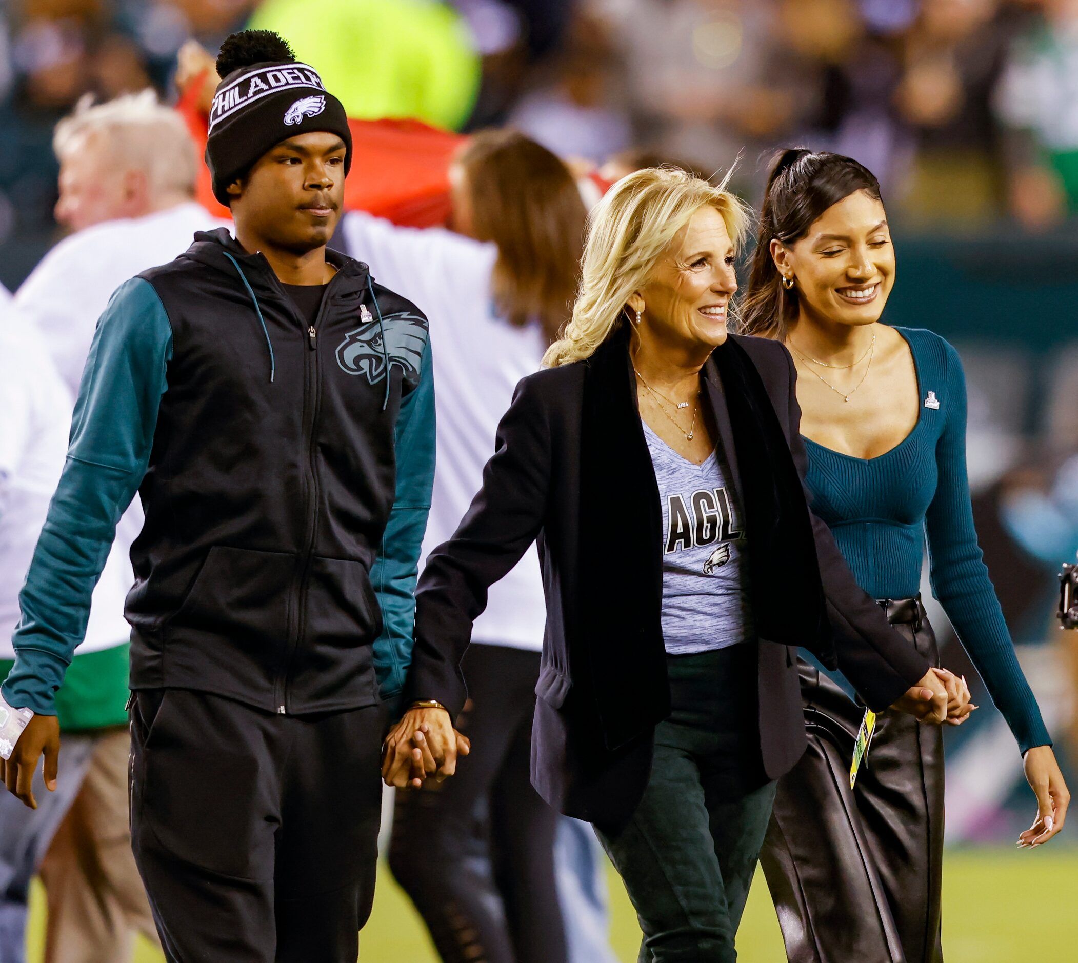 First Lady Jill Biden (center) walks off the field following the national anthem before the...