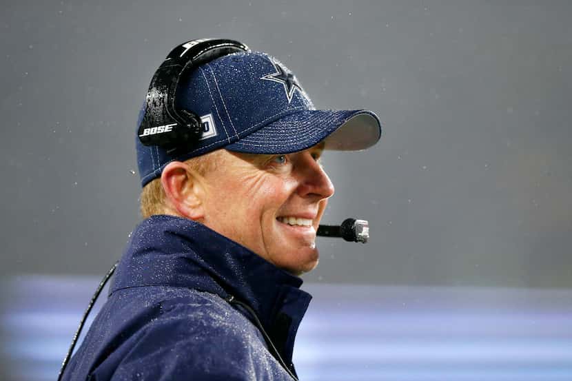 Dallas Cowboys head coach Jason Garrett watches his offense in a gusty rain at Gillette...
